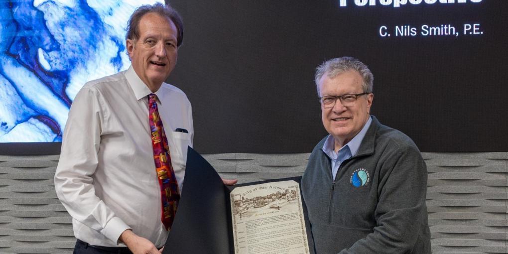 Nils Smith and Walt Downing hold up the City of San Antonio proclamation presented to IEEE.